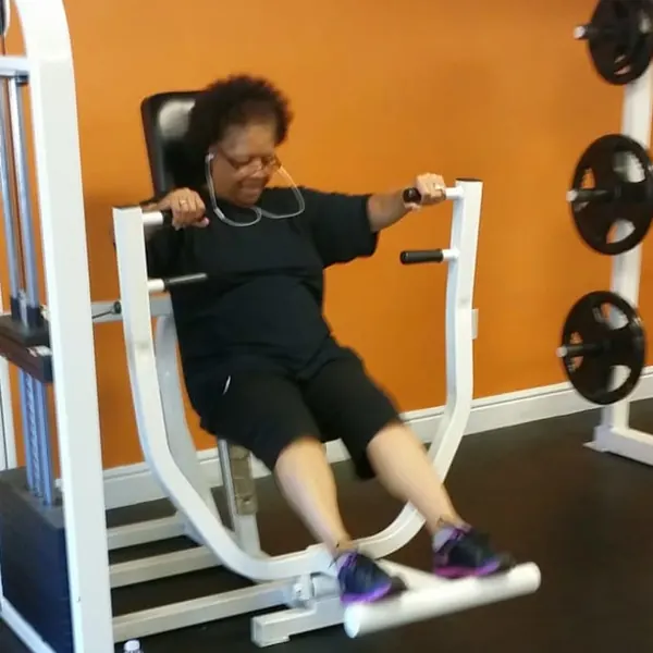 Barbara on a strength machine at the gym